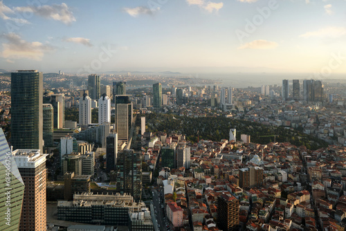 View from the window of a high-rise building to a modern city with skyscrapers, parks and sea coast. © SKfoto