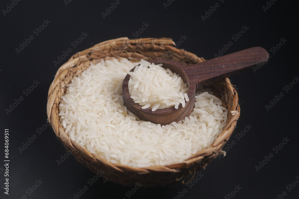 Raw white rice on a wooden spoon Raw white rice on a wooden spoon