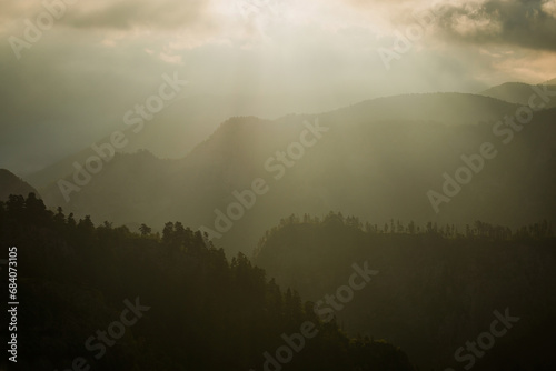 sunrise among the clouds over the mountains