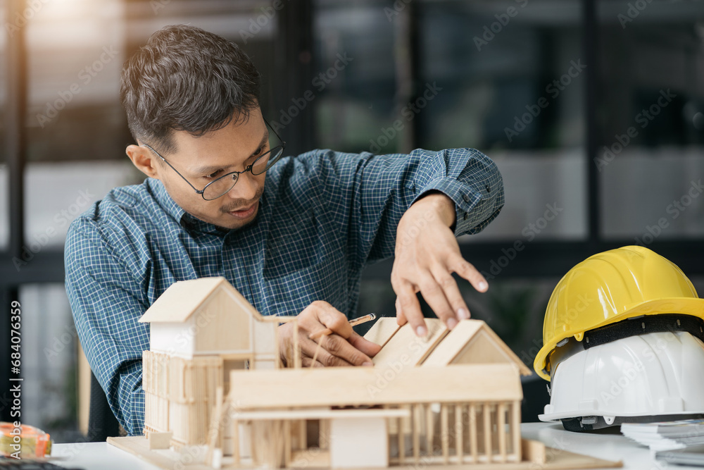 Close up of Engineer teams hands making model house. Engineer teams working in the office. Close up of Engineer teams hands making model house. Engineer teams working in the office.