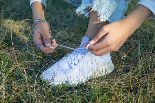 Woman tying shoe lace in outdoor.