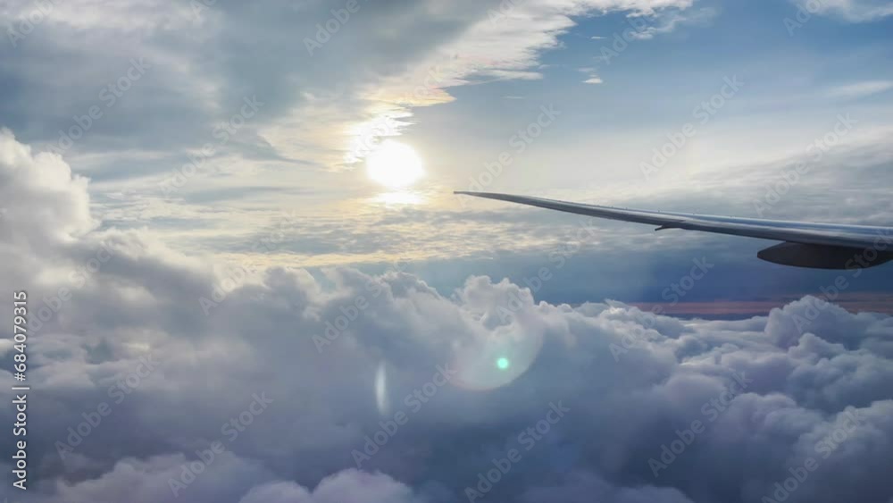 Airplane wing, view from window with beautiful sky and clouds Airplane wing, view from window with beautiful sky and clouds