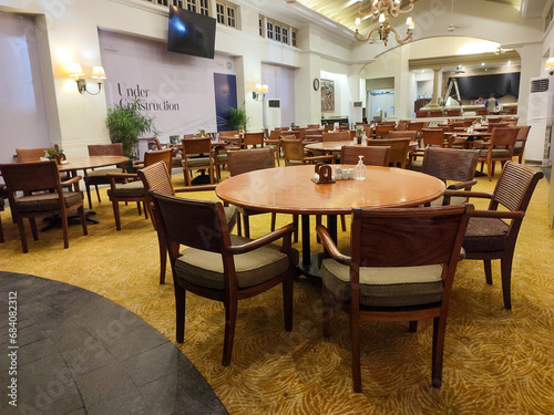 wooden tables and chairs are neatly arranged in the restaurant