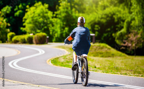 Wallpaper Mural Cyclist ride on the bike path in the city Park
 Torontodigital.ca