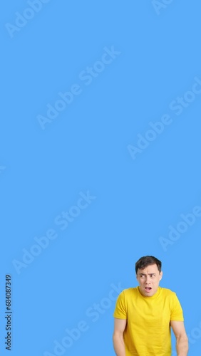Scared man gesturing with hands in fear and looking away