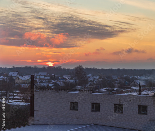 Shot of the dramatic sunset in the rural city in the cold morning. Season