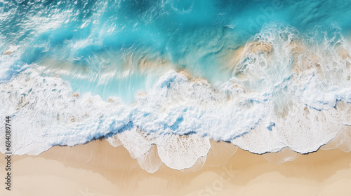 Swirling stream of sea water in pale blue water on a sandy beach background