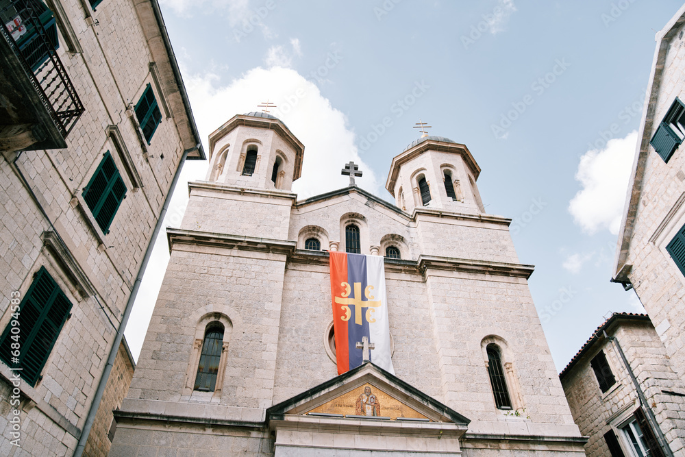 Flag of the Serbian Orthodox Church on the facade of the Church of St. Nicholas in Kotor. Montenegro