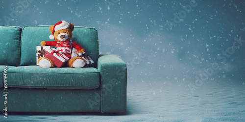 Cute teddy bear with Santa hat on the couch