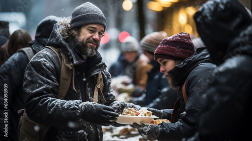 Volunteers distribute food to homeless people on a snowy city street