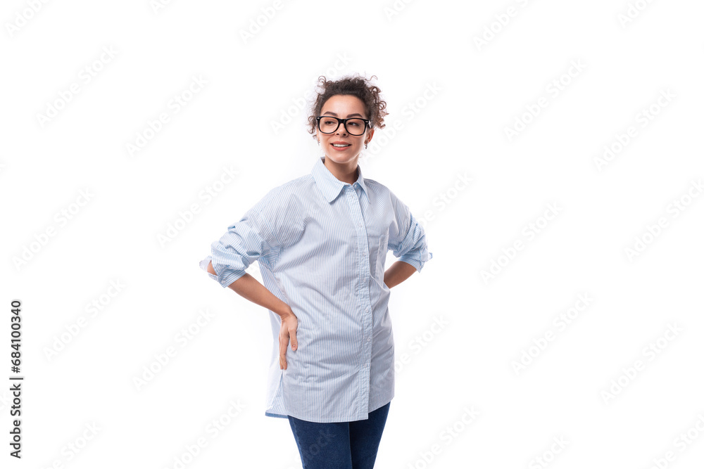 Fototapeta premium slender young brunette curly business woman dressed in a light blue shirt