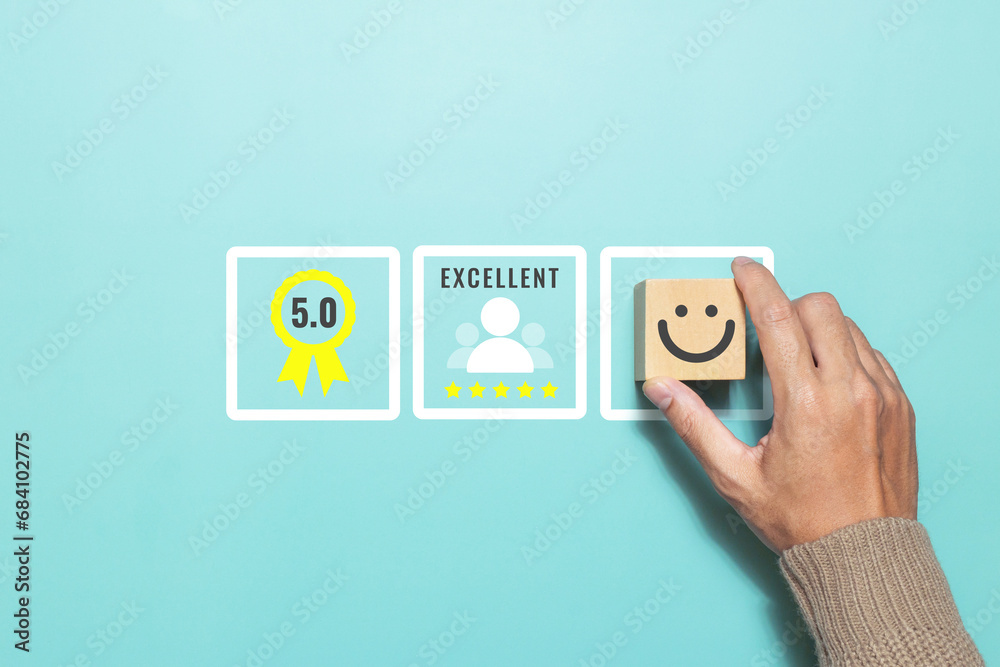 Customer putting smile face emoticon give a five star rating with rating feedback scale. Concept of service rating, satisfaction and feedback Customer putting smile face emoticon give a five star rating with rating feedback scale. Concept of service rating, satisfaction and feedback