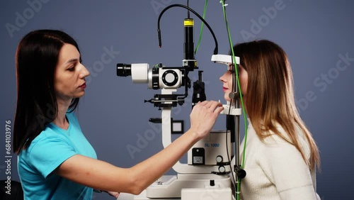 Eye examination and optometry to test your vision, medical consultation or glaucoma screening. Happy client with laser technology or eye scanning and ophthalmic test machine photo