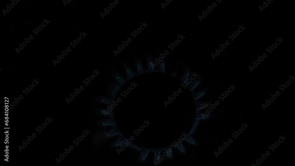 Unrecognizable woman hand turning on stove switch, lighting kitchen burner of gas stove indoors. Stove burner igniting into blue cooking flame. Natural gas inflammation. Close up, slow motion. Unrecognizable woman hand turning on stove switch, lighting kitchen burner of gas stove indoors. Stove burner igniting into blue cooking flame. Natural gas inflammation. Close up, slow motion.