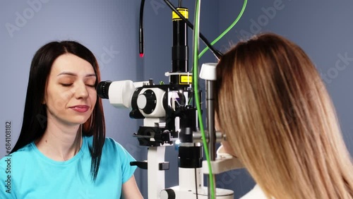 Eye examination and optometry to test your vision, medical consultation or glaucoma screening. Happy client with laser technology or eye scanning and ophthalmic test machine photo