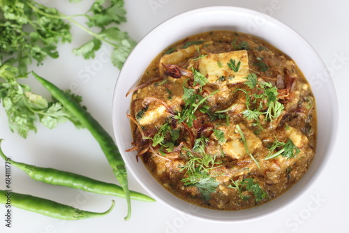 Delicious Paneer masala curry garnished with caramelized onions and coriander leaves made with cottage cheese prepared in yogurt gravy