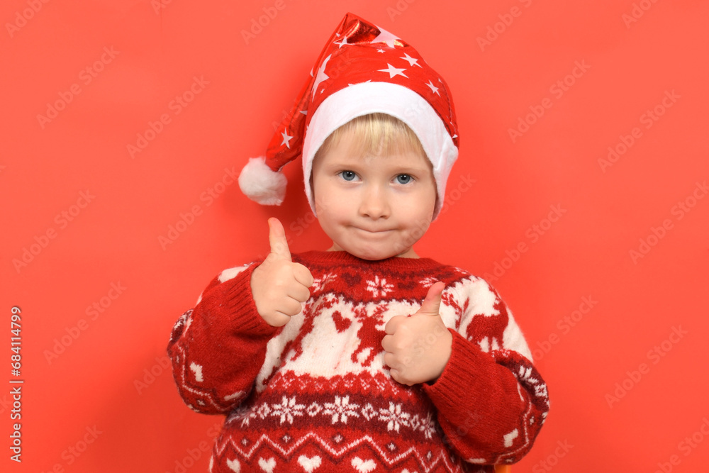 funny portrait of a boy, a child in a Santa Claus hat, Christmas funny portrait of a boy, a child in a Santa Claus hat, Christmas