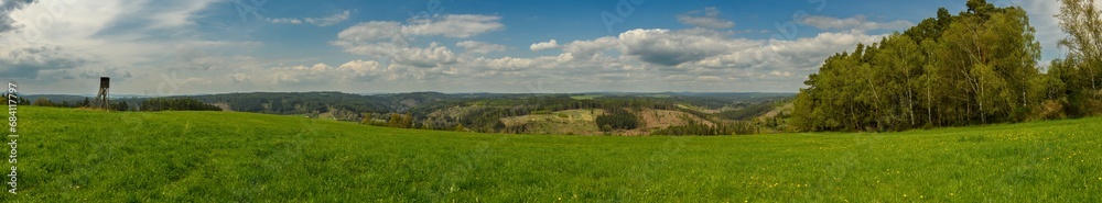panorama of country side with meadow, high seat and forest