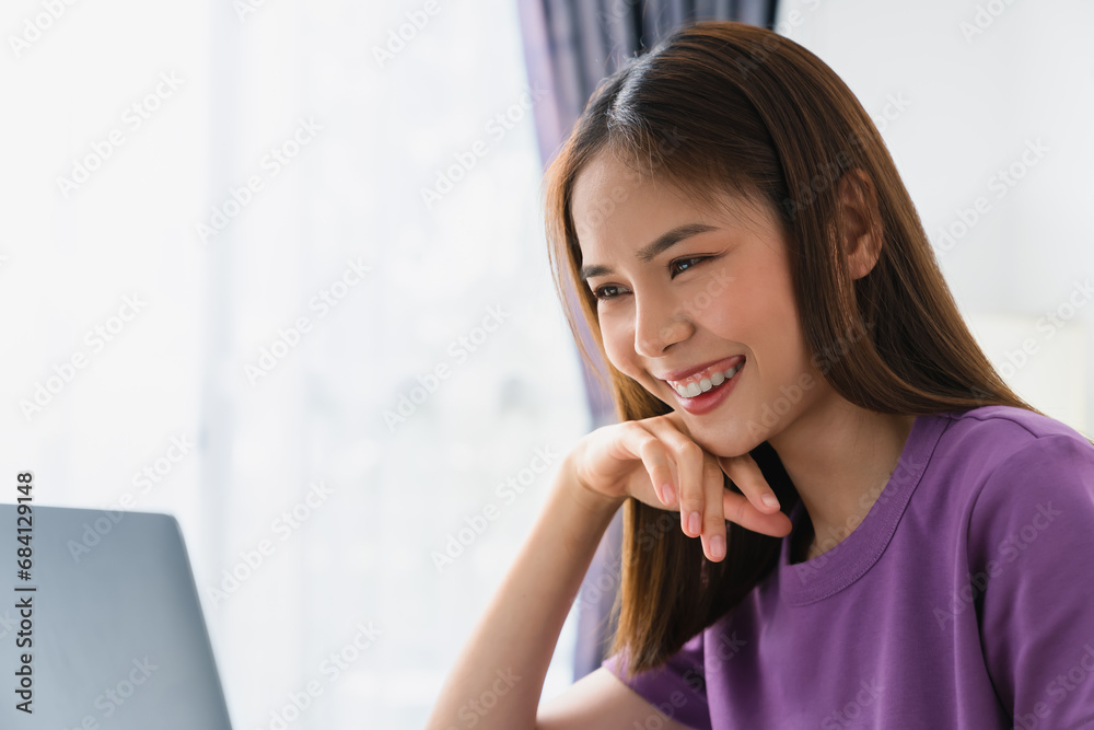 Young attractive female sitting at the desk and using laptop computer. Young attractive female sitting at the desk and using laptop computer.