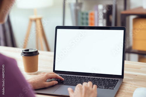 Woman hand type on the keyboard on laptop with mockup of blank screen for the application. photo