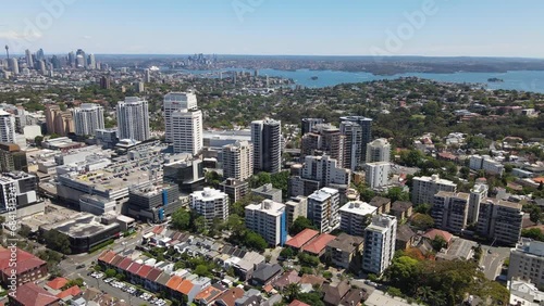 Aerial drone rotation view of Bondi Junction in the Eastern Suburbs of Sydney, NSW Australia with Sydney City in the background on a sunny day photo