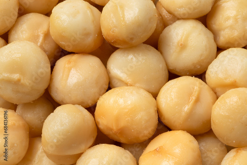 Shelled macadamia nuts full frame close up as background