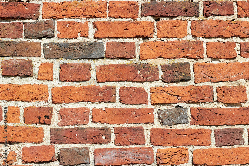Fototapeta premium Texture of a wall made of ancient red baked bricks