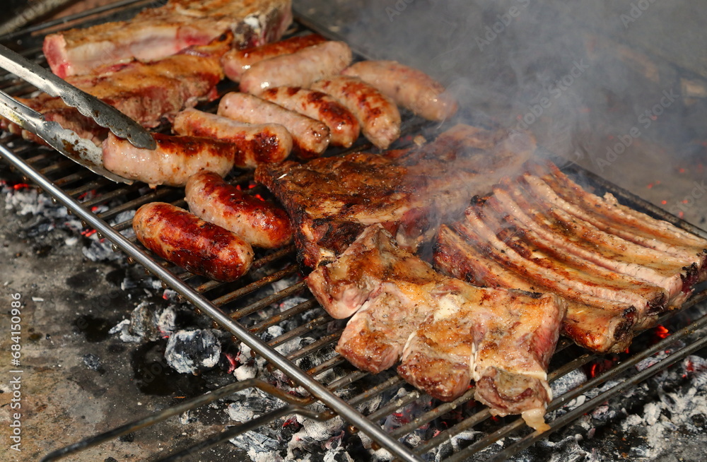 Barbecue Cooking with Sausages and Spare Ribs Cooked Over Flaming Embers Barbecue Cooking with Sausages and Spare Ribs Cooked Over Flaming Embers
