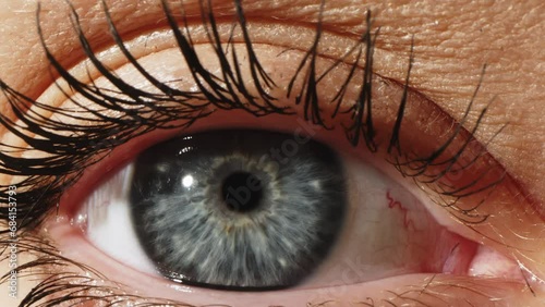 Grey Female Eye Close Up Extreme Macro Zoom 4K. Eyeball in opthalmology or optometry for eye exam or treatment zoom. Medical attendance at the optometrist in a bright modern clinic. Eye examination. photo