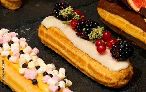 confectionery products garnished with sugary icing and fruit blackberries photo