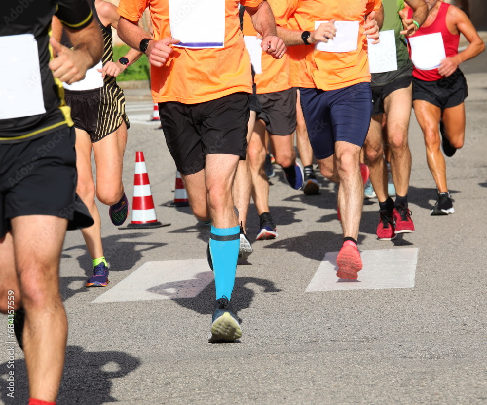 group of athletes runners in sports outfit while running foot race