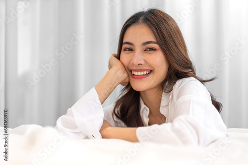 Portrait of smiling beautiful pretty asian woman clean fresh healthy white skin posing smile in pajamas white clothes, skincare, lady, model, cosmetic, fashion.Girl relax, enjoy at home.asia beauty