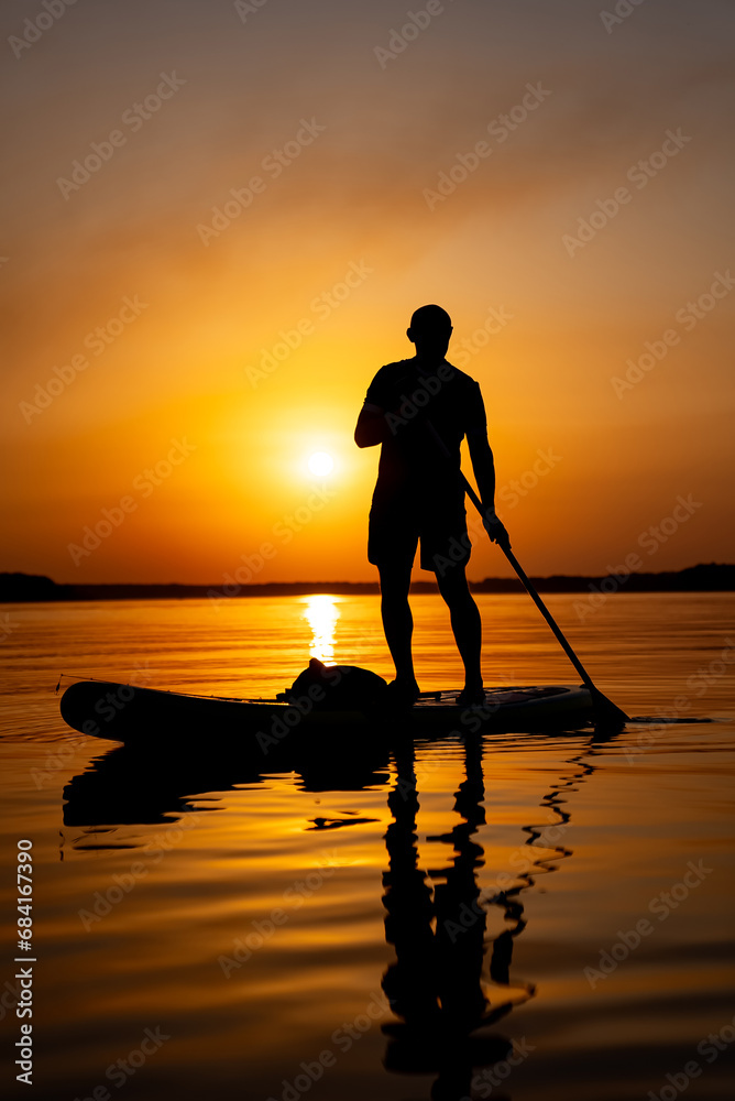 The Serene Stand-Up Paddleboarder Gliding on Calm Waters with Grace and Balance
