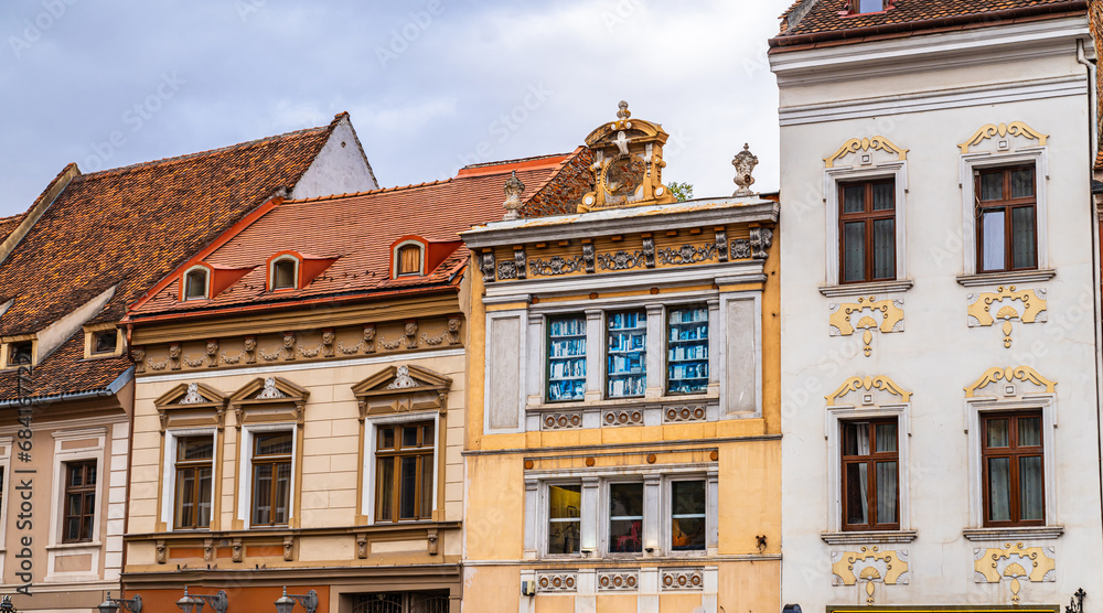 Fototapeta premium A White Van Parked in Front of a Tall Building