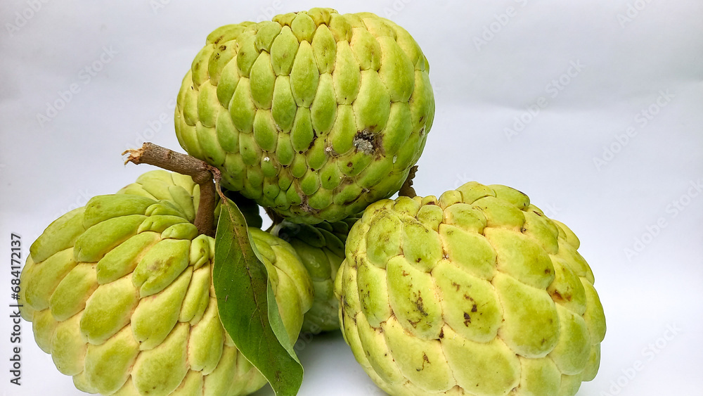 Fototapeta premium melwa fruit or nona fruit. This is the nona fruit in Indonesia. This fruit is similar to soursop but smaller. The taste is sweet and delicious