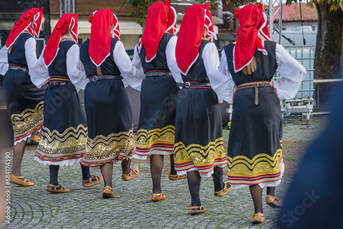People dressed with traditional Bulgarian authentic folklore clothes dancing folk dance photo