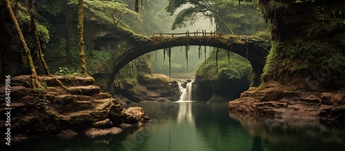 Natural landscape with bridge and river. A river with a small waterfall and a wooden bridge photo