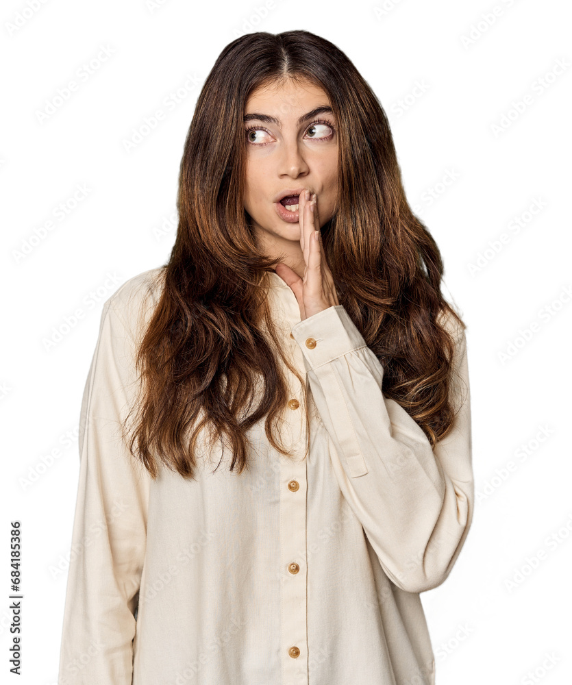 Young Caucasian woman in studio setting is saying a secret hot braking news and looking aside Young Caucasian woman in studio setting is saying a secret hot braking news and looking aside