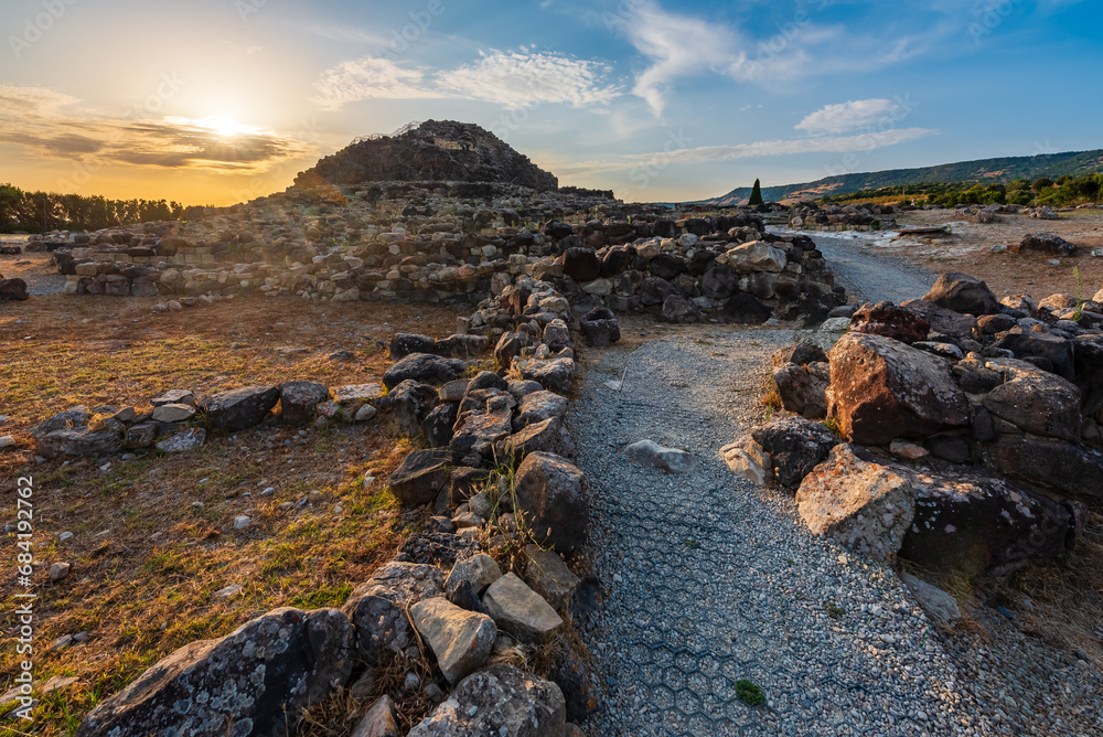 The bronze age fort UNESCO world heritage site Su Nuraxi di Barumini on Sardinia island during sunset.
