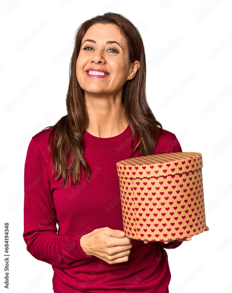 Middle-aged woman with Valentine's Day heart box in studio laughing and having fun. Middle-aged woman with Valentine's Day heart box in studio laughing and having fun.