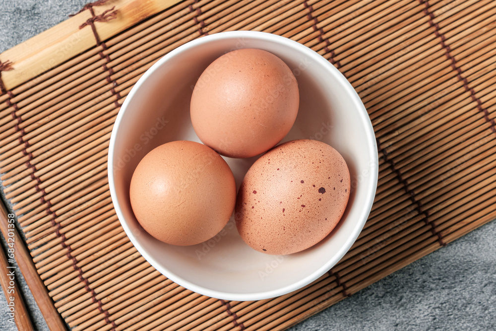 Chicken eggs in a white cup, to prepare for breakfast, nutrition concept. Chicken eggs in a white cup, to prepare for breakfast, nutrition concept.