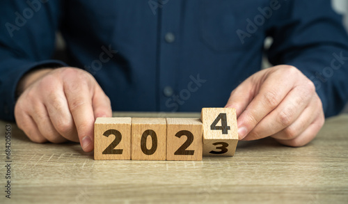 Change of 2023 to 2024. Reflecting on past achievements and experiences while looking forward for opportunities. Embracing new trends, making forecasts, and setting new plans for the upcoming year. photo