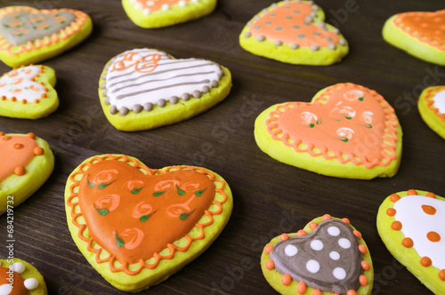 Heap of orange and yellow heart shaped with beautiful patterned royal icing cookies © jobi_pro