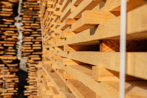 Close up of pine boards. Production of wood material on a sawmill