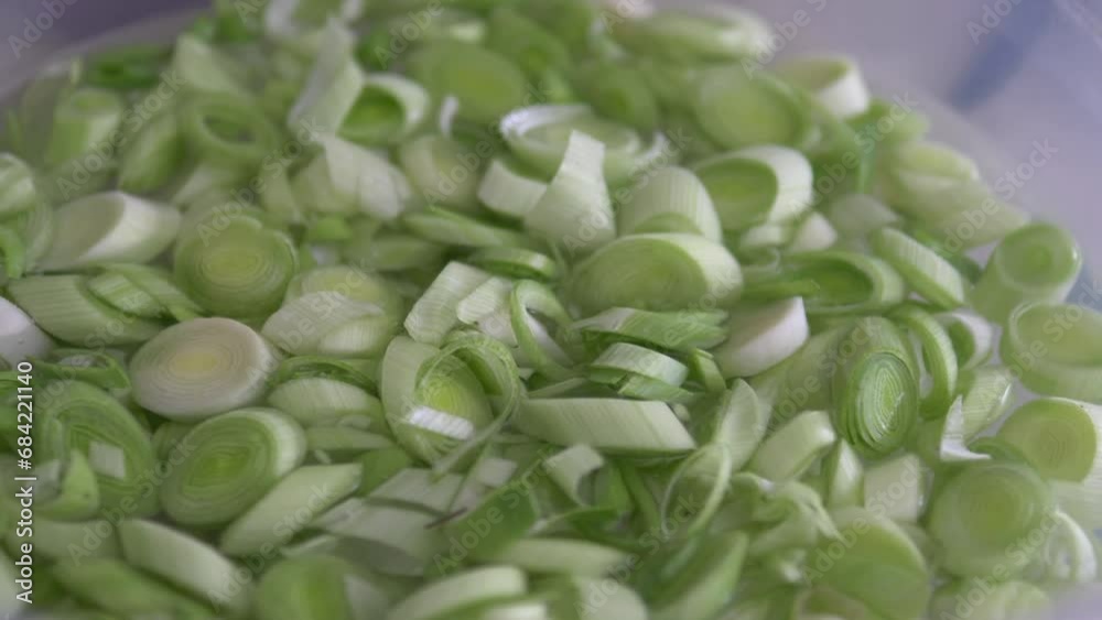 Chopped leeks for cooking are washed in a bowl, Chopped leeks for cooking are washed in a bowl,