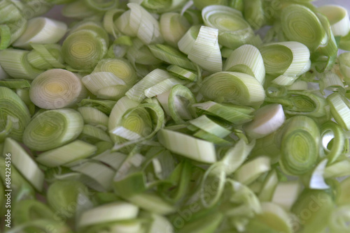 Chopped leeks for cooking are washed in a bowl, © kodbanker
