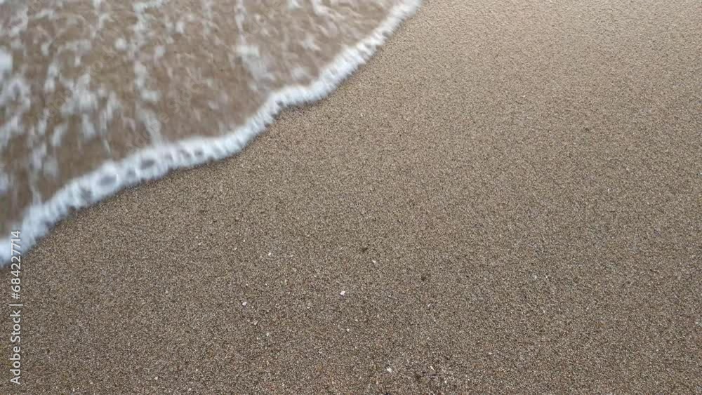 Top view, close up, sea waves moving on the white sand beach.