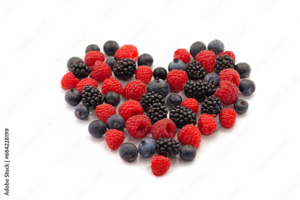 bright wild berries. fresh bright berries in the shape of a big heart lie on a white surface, creative concept bright wild berries. fresh bright berries in the shape of a big heart lie on a white surface, creative concept