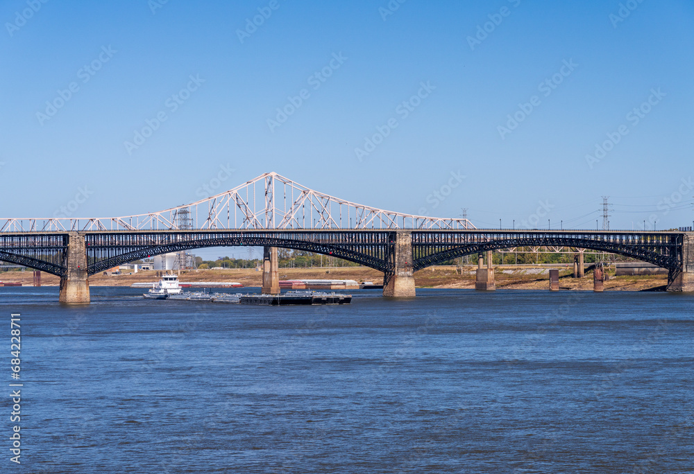 Powerful pusher tugboat with barges of petroleum products under Eads Bridge in St Louis, Missouri - obrazy, fototapety, plakaty 