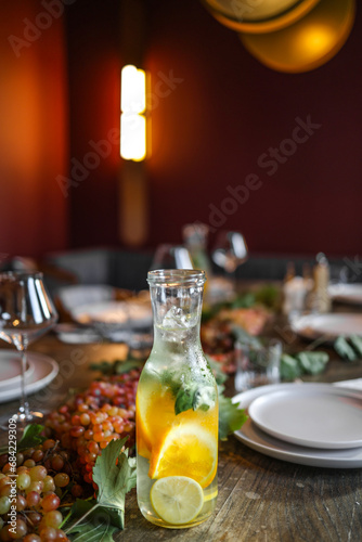 cold water bottle with lemon and orange on the table